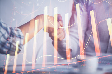 Double exposure of forex graph hologram and handshake of two men. Stock market concept.