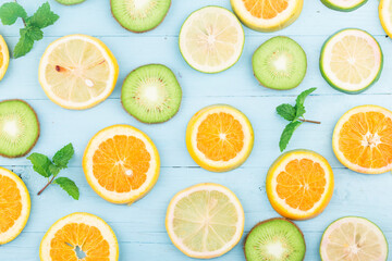 Poster - Fruit background. Colorful fresh fruit on Blue wooden board. Orange, kiwi,  lemon，Flat lay, top view,