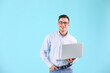 © Pixel-Shot - Male programmer with laptop on color background