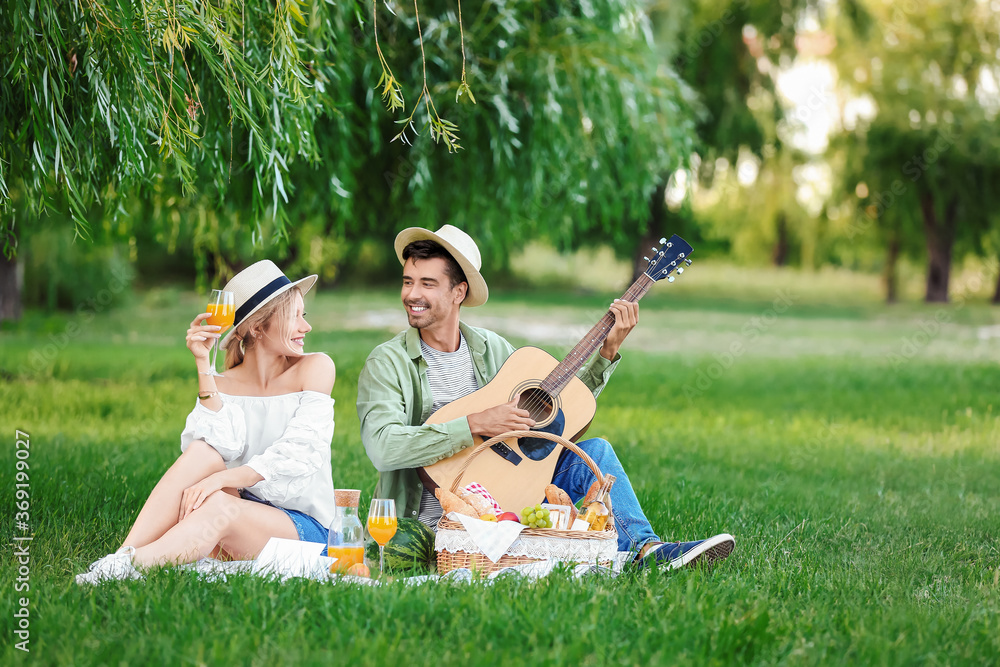 Happy young couple on picnic in park