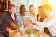 © Robert Kneschke - Students with tablet computer in the restaurant