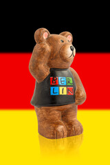 Wall Mural - Bear symbol of Berlin. Bear on the background of the flag of Germany.