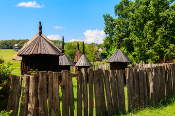 Ancient wooden beehives in old rural apiary