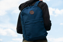 Close Up Of Blue Backpack On Mans Back On Sky Background, Mock Up, Place For Text