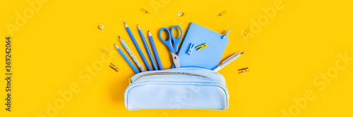 Cuadros en Lienzo Web banner with School writing materials: pencils, scissors, notepad, pen case on yellow background