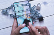 © adrian_ilie825 - Smartphone addiction concept with mobile device in woman hands with chains and locker