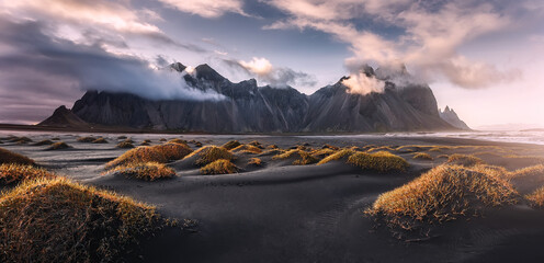 Stunning  dramatic landscape image with cloudy mountain in Iceland during sunset. Impressive Colorful Seascape of Iceland. Wonderful picturesque Scene  near Stokksnes cape and Vestrahorn Mountain