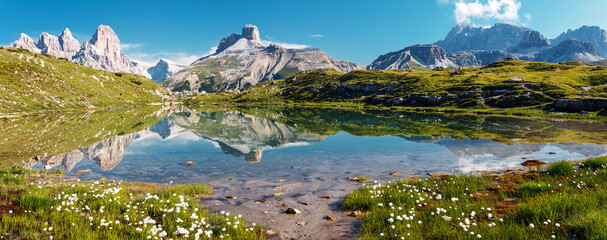 Fototapete - Awesome Alpine highlands in sunny day. Amazing Summer Landscape of Dolomites Alps. Wonderful Panoramic view at Mountains Range and calm lake on foreground of Tre Cime di Lavaredo National park