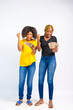 © Courage - young black beautiful ladies holding some naira note/bills and jubilating over winning the money