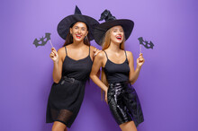 Two Young Women In Black Witch Costumes