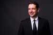 © Ranta Images - Portrait of happy handsome bearded businessman in suit