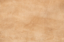 Light Beige Matte Background Of Suede Fabric, Closeup. Velvet Texture Of Seamless Sand Leather