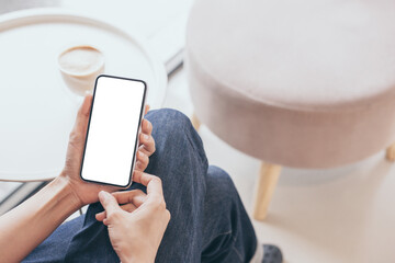 cell phone mockup image blank white screen.woman hand holding texting using mobile on desk at coffee shop.background empty space for advertise.work people contact marketing business,technology