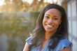 © Monkey Business - Portrait Of Smiling African American Woman In Garden At Home Against Flaring Sun