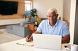 © Monkey Business - Senior African American Man Using Laptop To Check Finances At Home