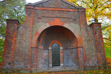 ancient red building in the woods