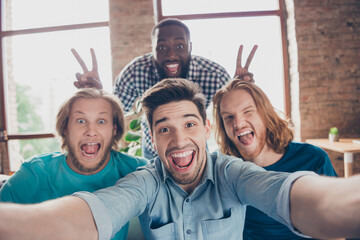 Sticker - Portrait of positive man blogger meeting enjoy free time make selfie fooling grimace face afro american man show v-sign imaginary rabbit ears in house indoors