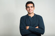 © Ranta Images - Portrait of happy young handsome Indian man smiling with arms crossed