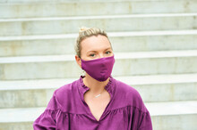 Outdoor Fashion Portrait Of Pretty Woman Wearing Purple Blouse And Facemask