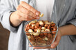 © Atlas - Woman hold bowl with different nuts. Healthy eating