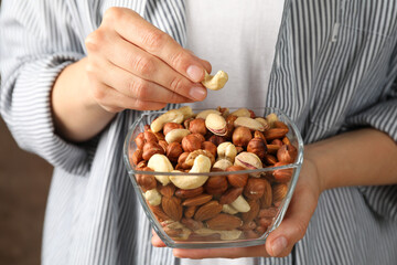 Wall Mural - Woman hold bowl with different nuts. Healthy eating