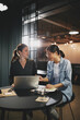 © Flamingo Images - Two diverse young businesswomen working in an office