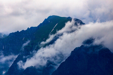 Canvas Print - Beautiful landscape with cliff mountain seen through morning fog.