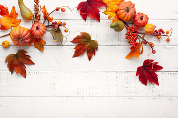 Poster - Festive autumn decor from pumpkins, berries and leaves on a white  wooden background. Concept of Thanksgiving day or Halloween. Flat lay autumn composition with copy space.