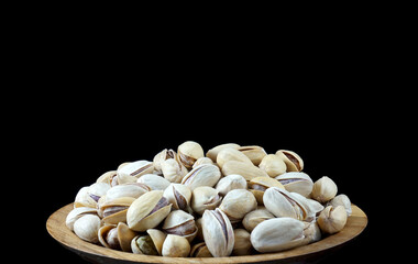 Heap of fish nuts on a plate on a black background