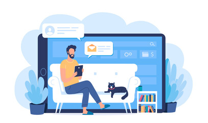 Young man working online at home on the comfortable sofa