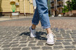 © Anatoly Repin - Close up of person walking on paving stone street at summer day