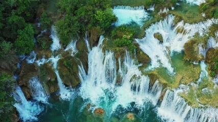 Wall Mural - Aerial view of beautiful mountain forest lake with waterfalls.