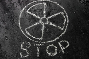symbol of nuclear weapons and radiation on a black background and the inscription stop. concept refuse