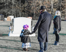 Loving Family Visits Recently Deceased At Cemetery 