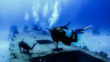 Scubadiving. Scuba divers diving at the shipwreck.