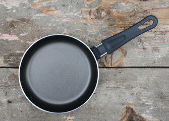 Wall Mural - An empty pan on a wooden table.