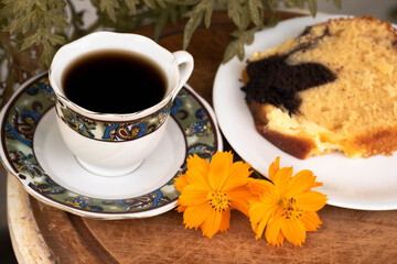 Traditional Greek coffee and pound cake for breakfast and two buds, flowers.