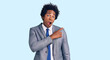 © Krakenimages.com - Handsome african american man with afro hair wearing business jacket surprised pointing with finger to the side, open mouth amazed expression.