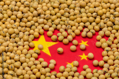 Flag of China covered in soybeans. Concept of Chinese agricultural imports, exports, trade, trade war, tariffs, production and commodity markets