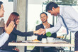 © aFotostock - Team Business Partners shaking hands together to Greeting Start up small business in meeting room. Shakehand teamwork partners at modern office handshake together. Business mergers and acquisitions