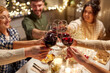 © Syda Productions - holidays, celebration and people concept - happy friends having christmas dinner at home drinking non-alcoholic red wine