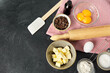 cooking food and culinary concept - rolling pin, butter, eggs, flour and chocolate on table