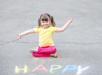 Little girl with syndrome down draws word 