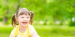 canvas print picture - Portrait of a joyful little girl with syndrome down in a summer park. Empty space for text