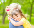 © Ermolaev Alexandr - Happy little girl with syndrom down hugs mother in a summer park