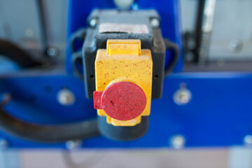 Sticker - Red orange on off safety switch on blue industral wood jointer planer close up shot