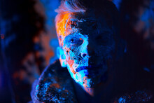 Close-up Portrait Of Man Covered With Powder Paint Against Black Background