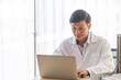 © ic36006 - Smiling Doctor Using Laptop On Table