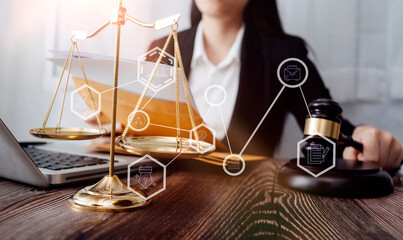 Justice and law concept.Male judge in a courtroom with the gavel, working with, computer and docking keyboard, eyeglasses, on table in morning light