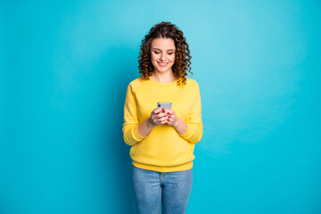 Wall Mural - Portrait of her she nice-looking attractive lovely pretty focused cheerful wavy-haired girl using device gadget sending sms isolated over bright vivid shine vibrant blue color background